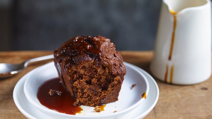 Vegan date sponge on a plate with a just of sauce